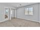 Bedroom showcasing neutral carpet, sliding closet doors, window and light, neutral paint, and white trim at 2638 Douglas Cir, Henderson, NV 89074