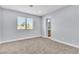 Bedroom featuring neutral carpet, a window and light, neutral paint, and white trim at 2638 Douglas Cir, Henderson, NV 89074