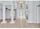 Grand foyer with tile flooring, decorative columns, and an elegant front door with glass inserts at 2638 Douglas Cir, Henderson, NV 89074