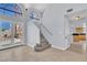 Bright foyer featuring unique staircase, tile flooring, and large windows allowing for abundant natural light at 2638 Douglas Cir, Henderson, NV 89074