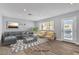 Staged living room with couch, chairs, projector, and modern decor at 2638 Douglas Cir, Henderson, NV 89074