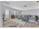 Virtually staged living room with hardwood floors, modern furnishings, and a large window at 2638 Douglas Cir, Henderson, NV 89074