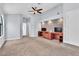 Large primary bedroom featuring carpet, ceiling fan, with built in desk and tv console at 2638 Douglas Cir, Henderson, NV 89074