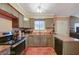 Traditional kitchen featuring painted cabinets, stainless steel appliances, and terracotta tile flooring at 2725 S Nellis Blvd # 2179, Las Vegas, NV 89121