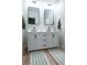 Bathroom with a double vanity and large mirrors at 306 Rodarte St, Henderson, NV 89014