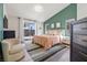 Stylish bedroom with green accent wall, rug, and neutral furniture at 306 Rodarte St, Henderson, NV 89014