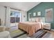 Stylish bedroom with green accent wall, rug and neutral furniture at 306 Rodarte St, Henderson, NV 89014