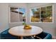 Cozy dining area featuring a round table with seating and bright natural light from the windows at 306 Rodarte St, Henderson, NV 89014