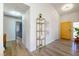 Stylish foyer with wood flooring, yellow door, decor shelving and modern light fixtures at 306 Rodarte St, Henderson, NV 89014