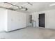 Bright garage with built-in storage cabinets, access door to the interior, and neutral painted walls at 306 Rodarte St, Henderson, NV 89014