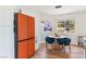 Modern kitchen featuring colorful refrigerator, dining area with seating, and wood-style floors at 306 Rodarte St, Henderson, NV 89014