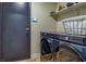 Modern laundry room with stacked washer/dryer, shelving, and sleek design providing convenient functionality at 306 Rodarte St, Henderson, NV 89014