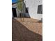 Private side yard features low maintenance gravel landscaping and mature shade tree at 306 Rodarte St, Henderson, NV 89014