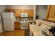 Well-lit kitchen featuring white appliances and light wood cabinets at 379 Rosado Springs St, Henderson, NV 89014