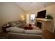 Bright living room with fireplace, vaulted ceiling, and sliding glass doors at 379 Rosado Springs St, Henderson, NV 89014