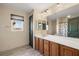 Bathroom with a large vanity, wood cabinets, and natural light at 3938 E Chaffe Ave, Pahrump, NV 89061