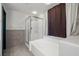 Bathroom with a tub and shower featuring glass doors at 3938 E Chaffe Ave, Pahrump, NV 89061