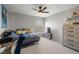 Bedroom with light-colored carpet, dark ceiling fan, and a window at 3938 E Chaffe Ave, Pahrump, NV 89061