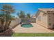 Lush green lawn and a kidney-shaped pool, complete with a custom patio and block wall in backyard at 4032 Rustic Oak Ct, North Las Vegas, NV 89032