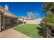 Lush green lawn and covered patio area, providing a relaxing outdoor space perfect for entertainment and leisure at 4032 Rustic Oak Ct, North Las Vegas, NV 89032