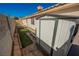 Metal storage shed in the backyard, along a landscape area with artificial turf and a concrete walkway at 4032 Rustic Oak Ct, North Las Vegas, NV 89032