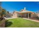 Expansive backyard with lush green lawn, covered patio, a kidney-shaped pool, and mature landscaping at 4032 Rustic Oak Ct, North Las Vegas, NV 89032