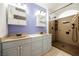 Bright bathroom with double sinks, vanity and walk in shower with a rainfall shower head at 4032 Rustic Oak Ct, North Las Vegas, NV 89032