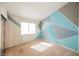 Bedroom featuring carpet, geometric accent wall, and a sliding glass closet at 4032 Rustic Oak Ct, North Las Vegas, NV 89032