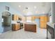 Bright kitchen with stainless steel appliances, tile floors, light-colored wood cabinets and an island at 4032 Rustic Oak Ct, North Las Vegas, NV 89032