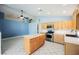 Bright kitchen with an island, stainless steel appliances, tile floors and light-colored wood cabinets at 4032 Rustic Oak Ct, North Las Vegas, NV 89032