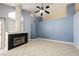 Cozy living room featuring a black tiled fireplace, tile flooring, and tall ceilings at 4032 Rustic Oak Ct, North Las Vegas, NV 89032