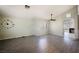 Spacious living room featuring laminated floors, modern ceiling fan, and ample natural light at 4032 Rustic Oak Ct, North Las Vegas, NV 89032