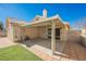 This home has a covered patio area with ceiling lighting, a grassy space, and easy access to the home's interior at 4032 Rustic Oak Ct, North Las Vegas, NV 89032