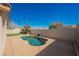 Backyard view of a kidney-shaped pool with a custom patio, privacy fence, and well-maintained landscaping at 4032 Rustic Oak Ct, North Las Vegas, NV 89032