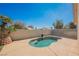 Backyard view of a kidney-shaped pool with a custom patio, mature trees, and a privacy fence at 4032 Rustic Oak Ct, North Las Vegas, NV 89032