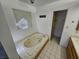 Bathroom with a jacuzzi tub, tiled floors and single sink vanity at 4055 Nook Way # A, Las Vegas, NV 89103