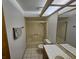 Bathroom featuring a shower-tub combo, single sink vanity, large mirror and tiled floors at 4055 Nook Way # A, Las Vegas, NV 89103