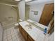 Well-lit bathroom featuring a shower-tub combo with a single sink vanity and tiled floors at 4055 Nook Way # A, Las Vegas, NV 89103