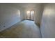 Empty carpeted bedroom featuring a light-filled room with patio access through glass paneled doors at 4055 Nook Way # A, Las Vegas, NV 89103