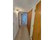 Hallway featuring carpet flooring and wooden closet doors at 4055 Nook Way # A, Las Vegas, NV 89103