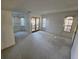 Spacious living room featuring neutral carpet flooring, white walls and many windows at 4055 Nook Way # A, Las Vegas, NV 89103