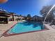 A community pool with clear blue water is surrounded by lounge chairs and lush landscaping at 4055 Nook Way # A, Las Vegas, NV 89103