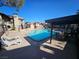 Community pool with lounge chairs and covered seating area on a sunny day at 4055 Nook Way # A, Las Vegas, NV 89103