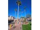 Condo complex street with large palm trees and American flag at 4055 Nook Way # A, Las Vegas, NV 89103