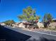 Street view of condo community with lush trees and well-maintained grounds at 4055 Nook Way # A, Las Vegas, NV 89103