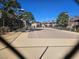 View of a tennis court with neighborhood buildings in the background at 4055 Nook Way # A, Las Vegas, NV 89103