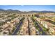 An aerial view of a neighborhood nestled against mountains in a desert landscape at 4288 Veraz St, Las Vegas, NV 89135