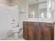A bright bathroom with a shower-tub combo, modern vanity, and a large mirror to enhance the space at 4288 Veraz St, Las Vegas, NV 89135