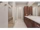 Modern bathroom features dual sinks, wood cabinetry, and a tiled walk-in shower at 4288 Veraz St, Las Vegas, NV 89135