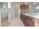 Modern bathroom with dual sink vanity, spacious shower with built-in bench, and stylish neutral tile at 4288 Veraz St, Las Vegas, NV 89135